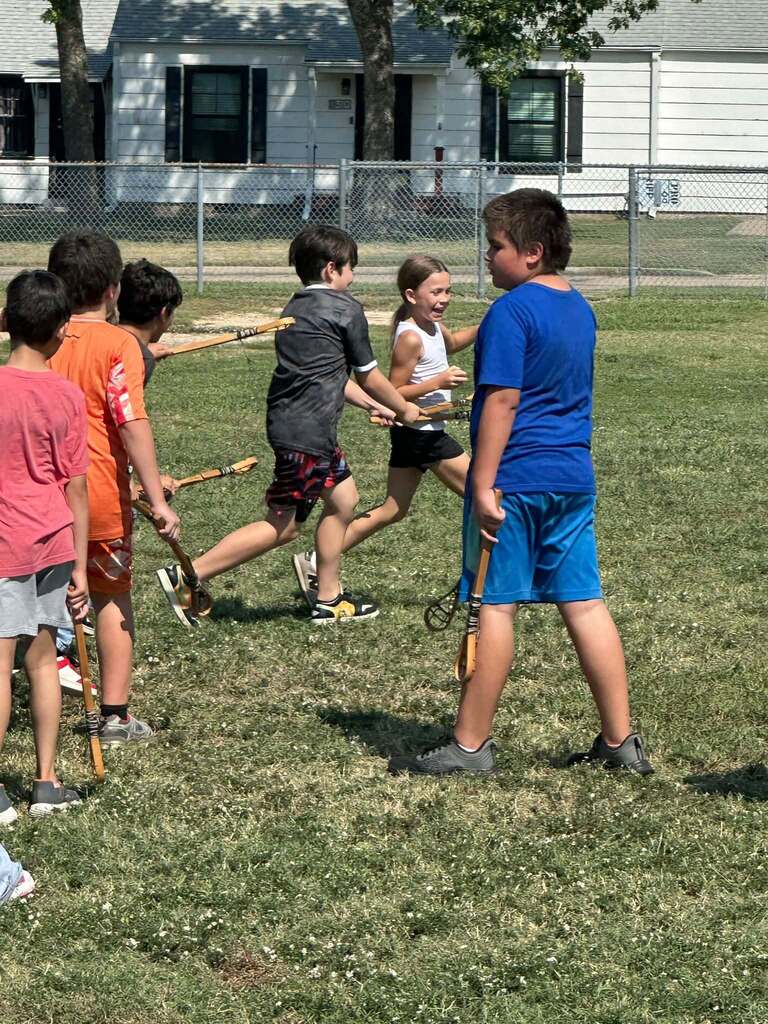 6 students participating in heritage day games, smiling