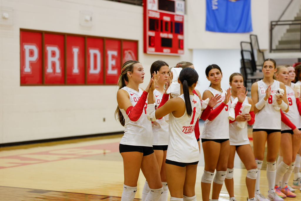 Lady Zebra volleyball players exchange high-fives before a match.