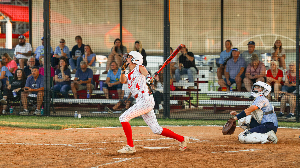 Lady Zebra batter swings at a pitch during a game.