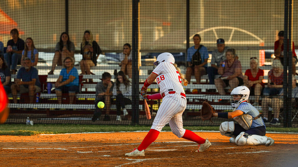 Lady Zebra batter swings at a pitch during a game.