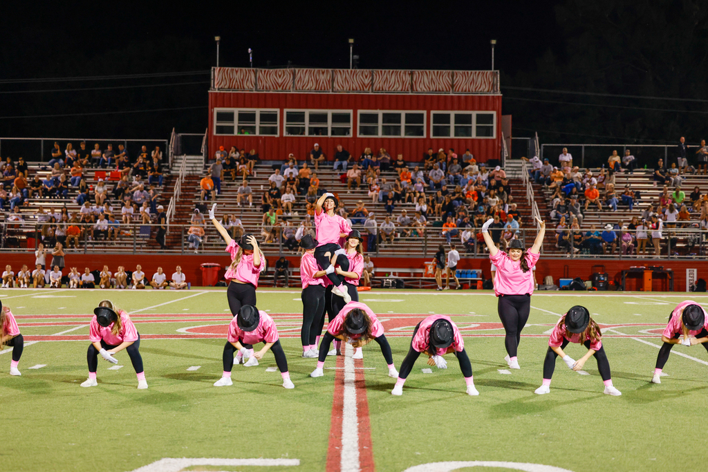 CHS dance team preforming on senior night in pink out shirts with Micheal Jackson Inspired hats