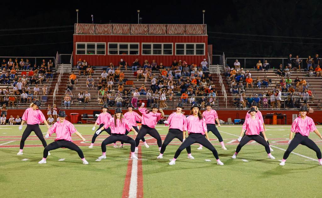 CHS dance team preforming on senior night in pink out shirts with Micheal Jackson Inspired hats