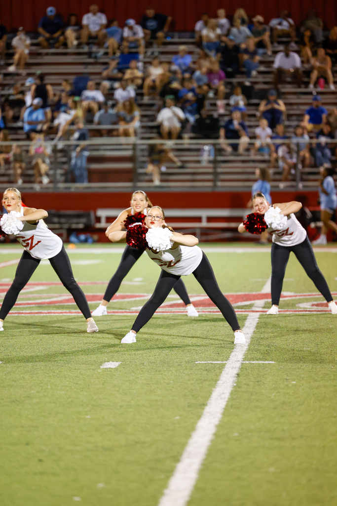 CHS dance team preforming at halftime in their CZ tank tops and black leggings in a sassy pose during routine