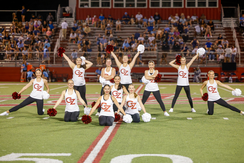 CHS dance team preforming at halftime in their CZ tank tops and black leggings all striking a pose at the end of their routine
