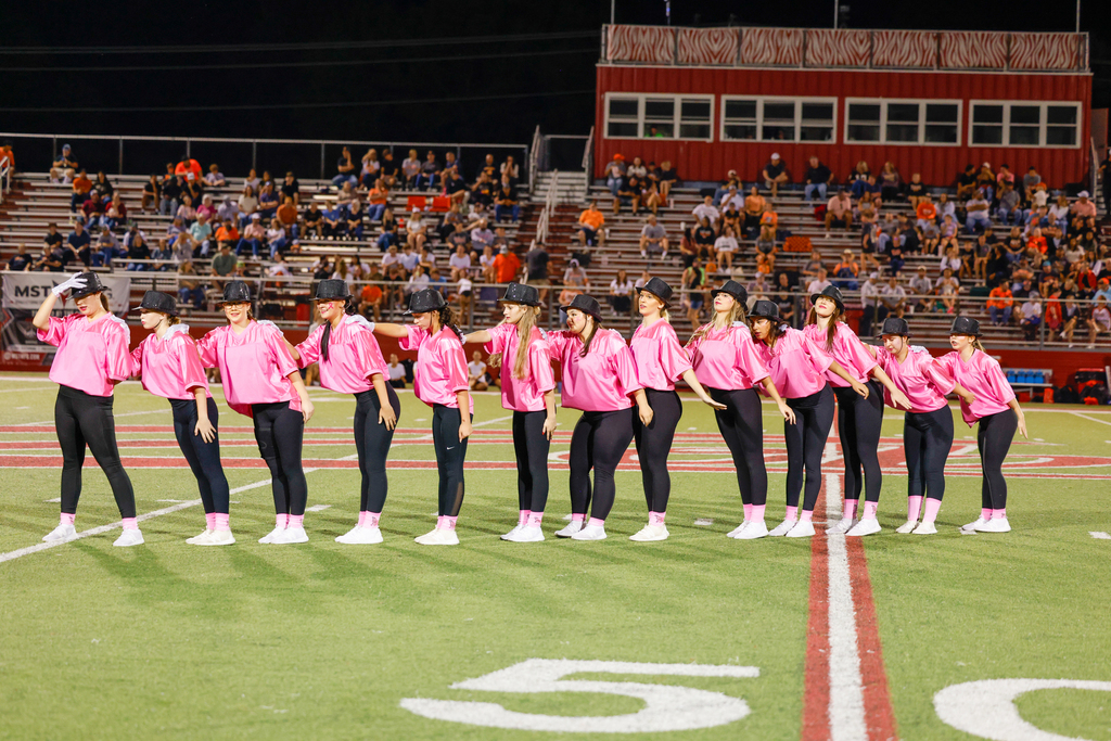 CHS dance team preforming on senior night in pink out shirts with Micheal Jackson Inspired hats