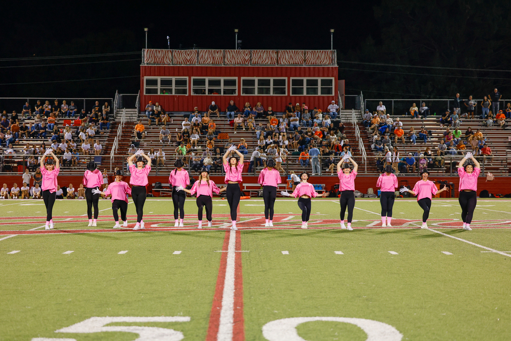 CHS dance team preforming on senior night in pink out shirts with Micheal Jackson Inspired hats