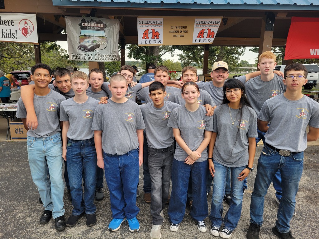 Claremore NJROTC cadets pose for a group photo in matching gray shirts beneath the Route 66 Cruisers banner.