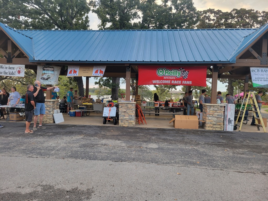 Wide view of the Route 66 Cruisers Car Show pavilion, where cadets and volunteers prepare for the event.