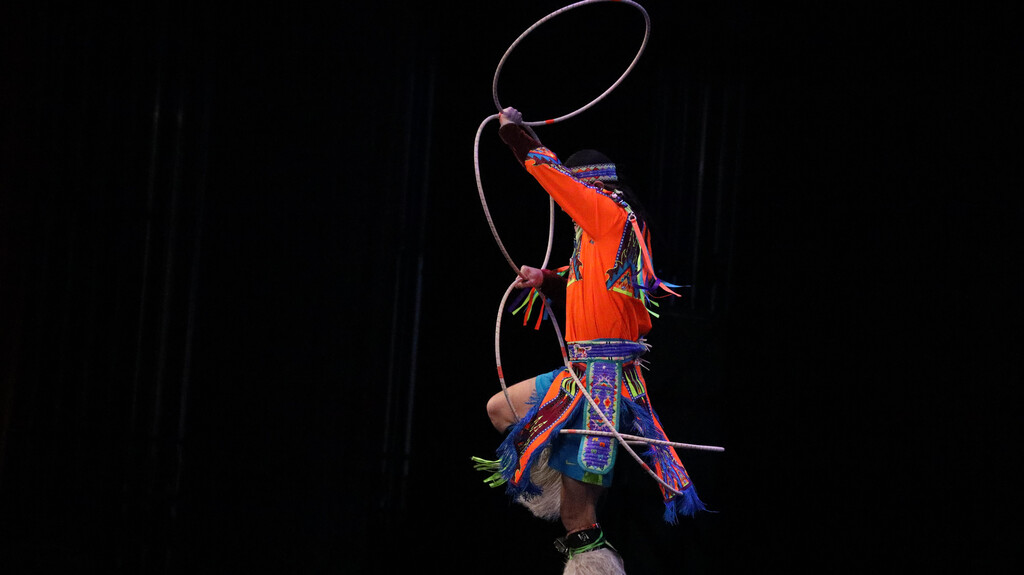 Rising Buffalo dancer performing with hoops on stage.
