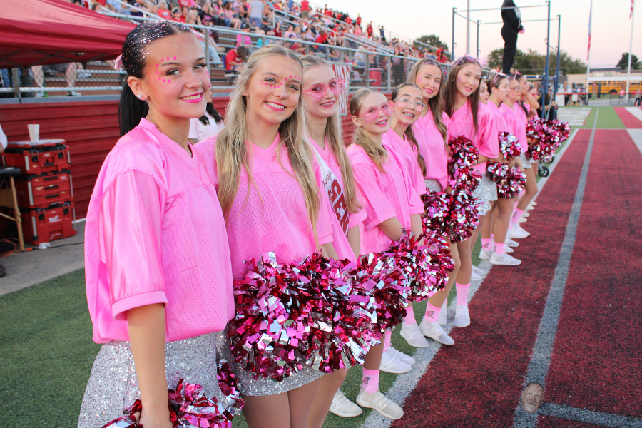 Claremore dancers pose in pink along the sideline.