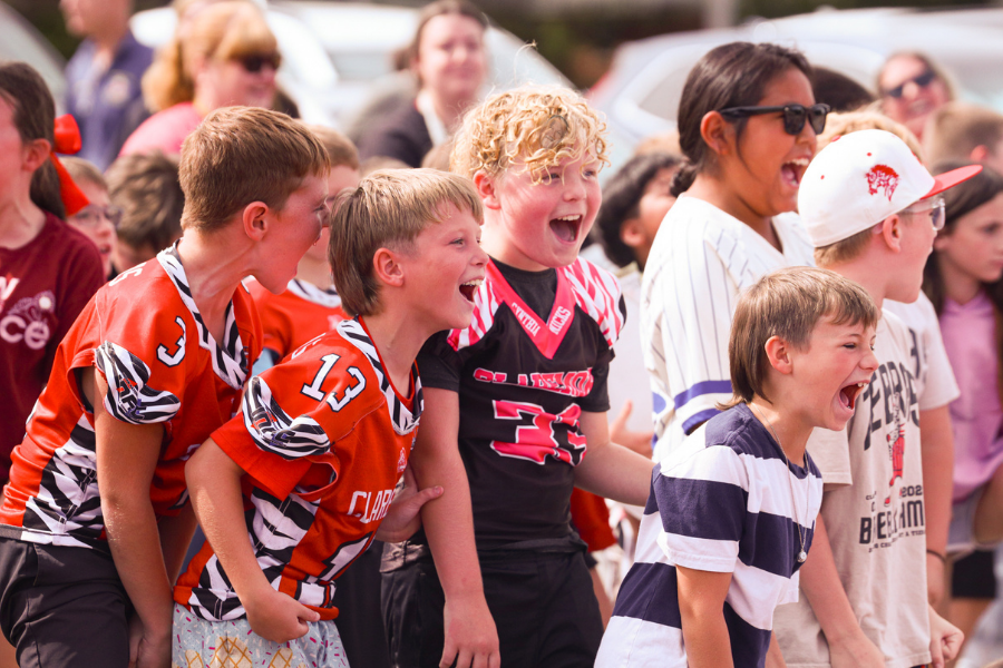 Young Zebra fans cheer at a school event.