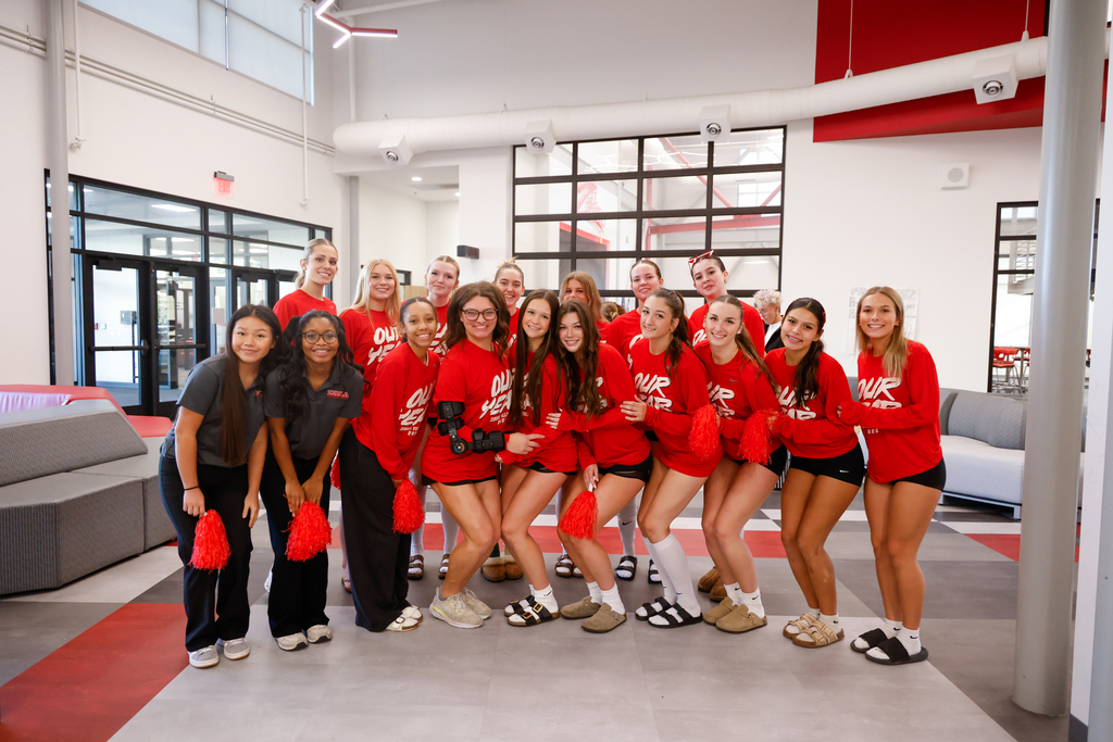 Lady Zebra volleyball players pose together in red shirts before their State Tournament send-off.