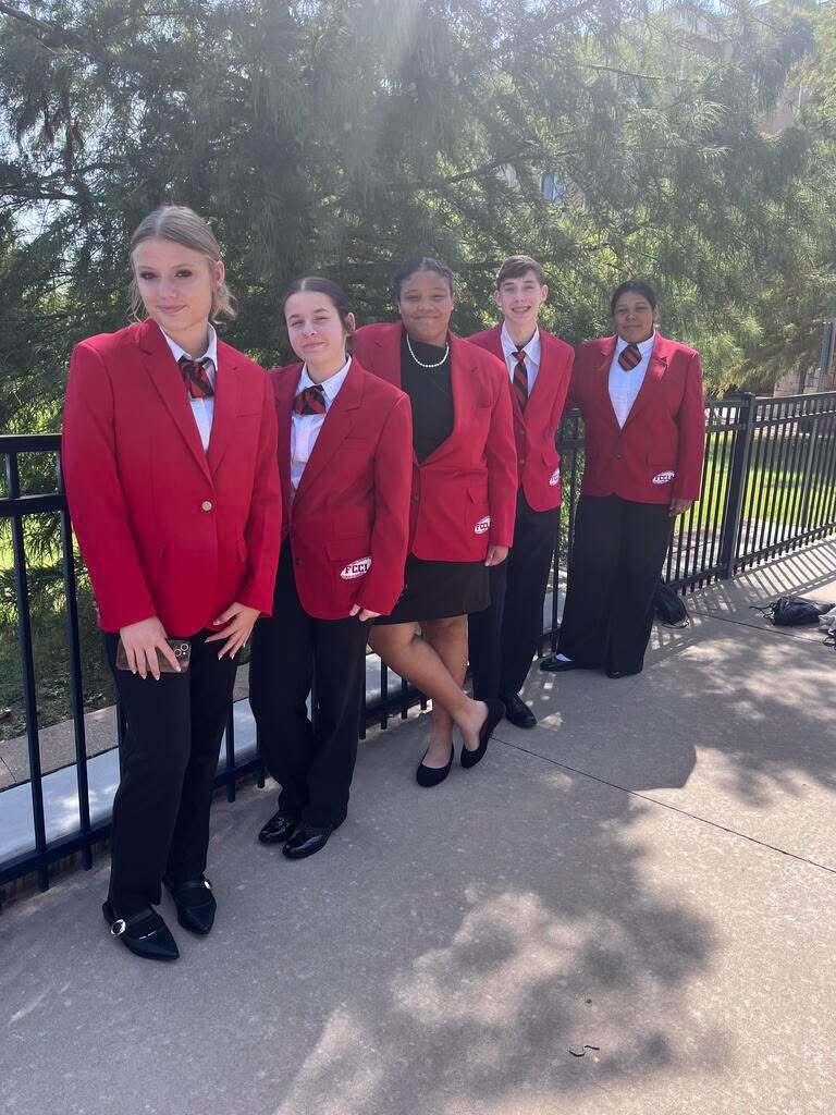 FCCLA students dressed up in front of gate