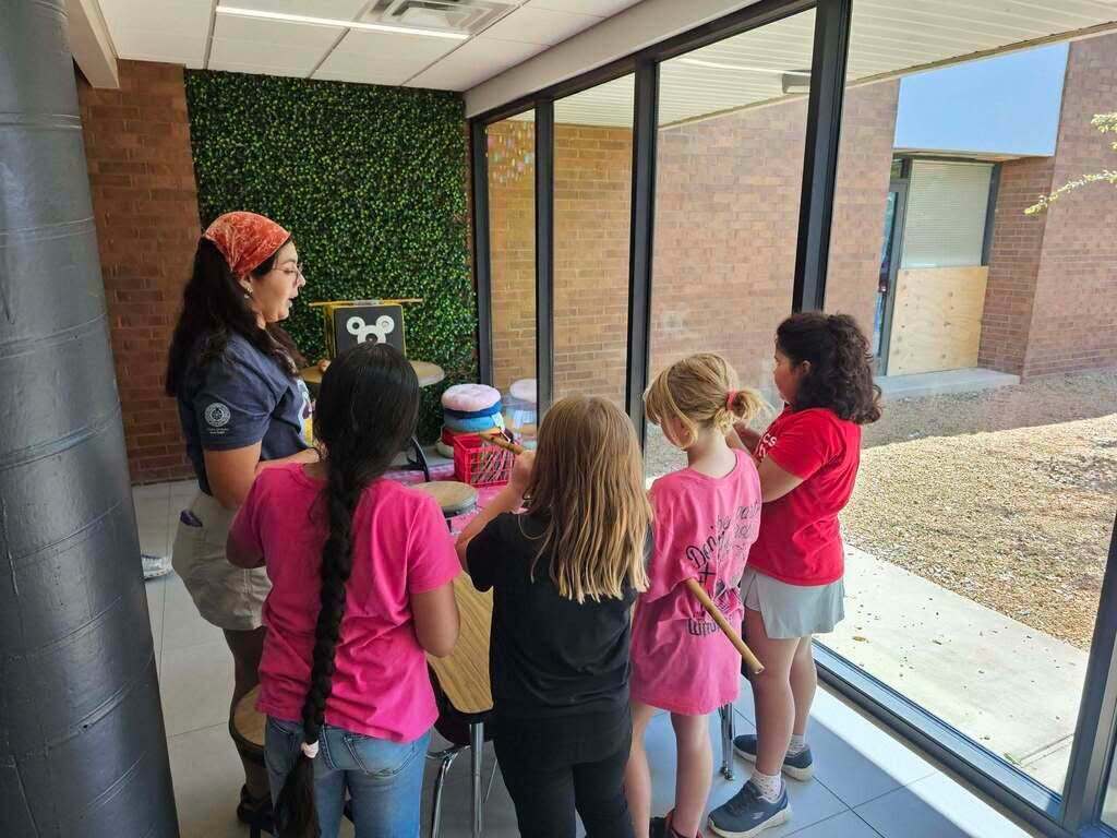 Students participate in a Cherokee cultural demonstration with an instructor.