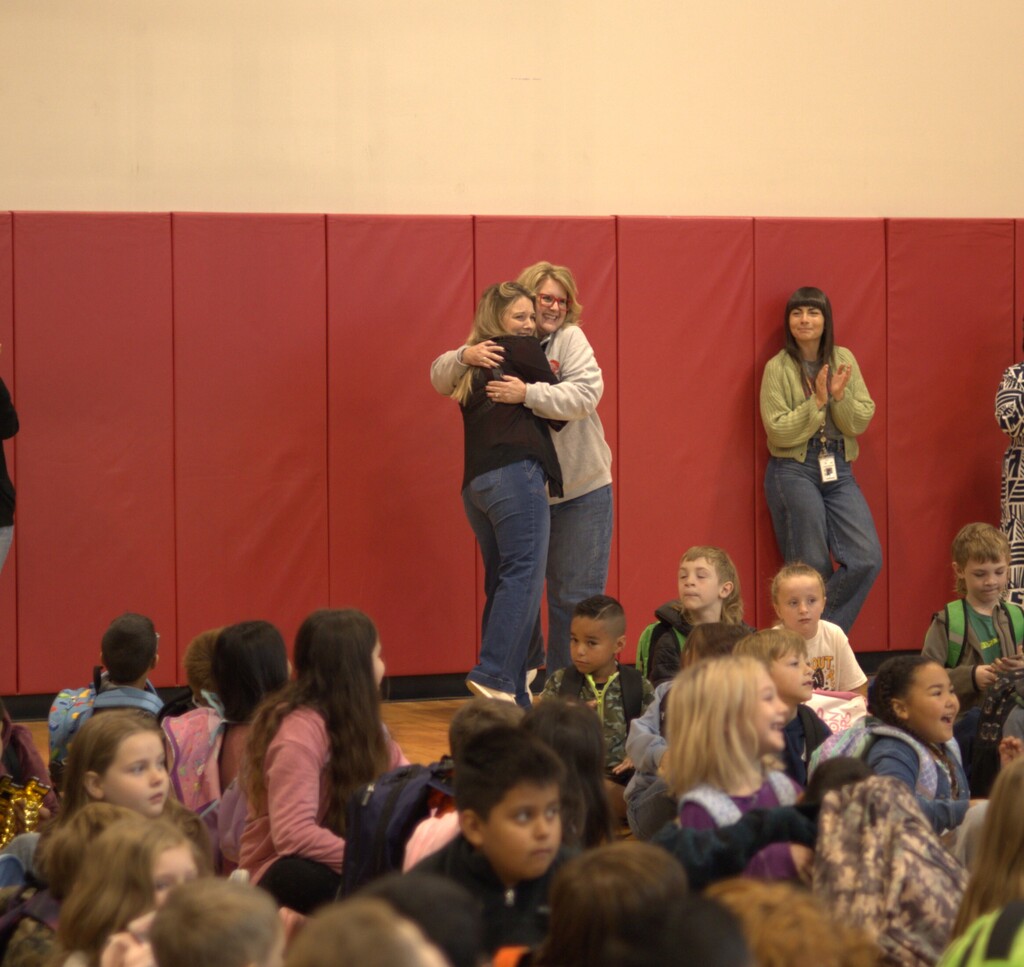 Two teachers hugging
