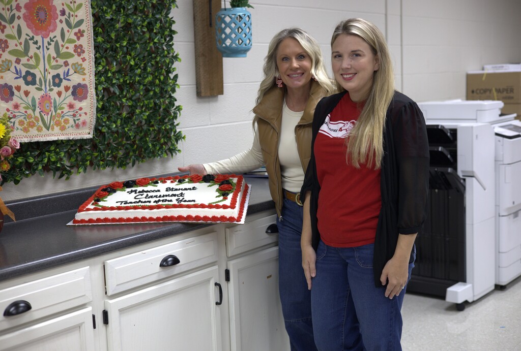 Mrs. Stanart and Ms Fay with a cake