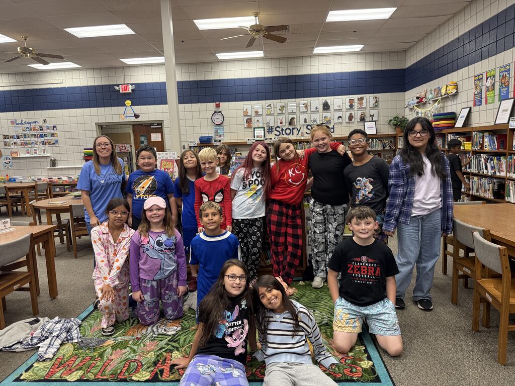 multiple students smiling for a photo wearing pjs or blue