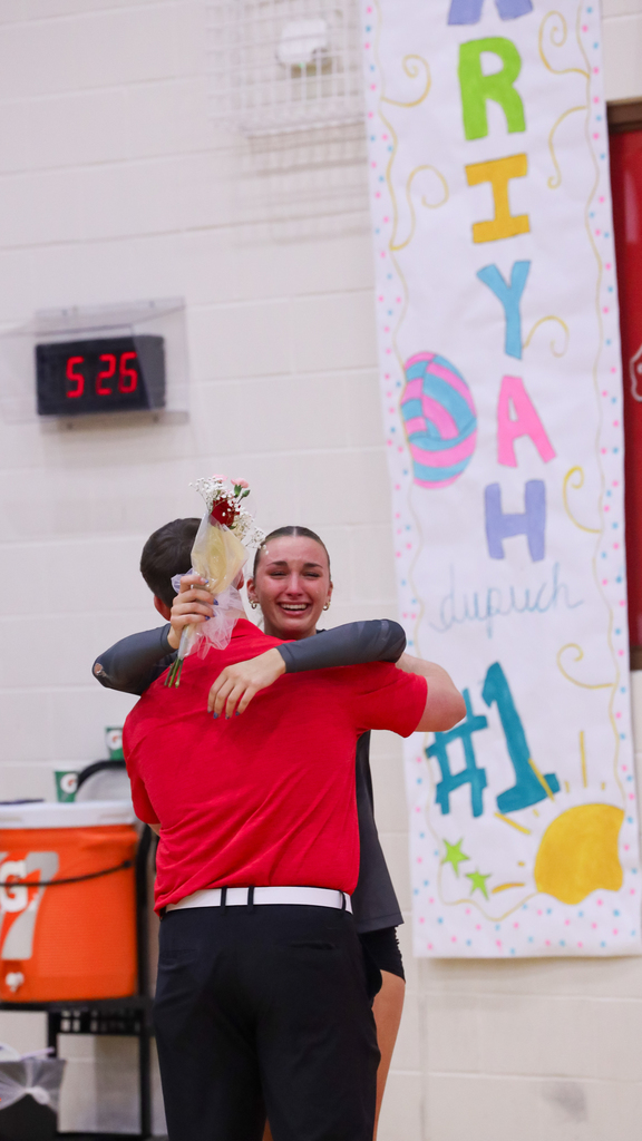 An emotional Claremore volleyball player hugs a family member during Senior Night.
