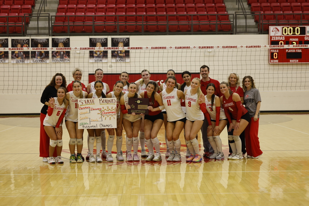 Claremore volleyball players and coaches pose with their Regional Championship plaque and State Bound sign.