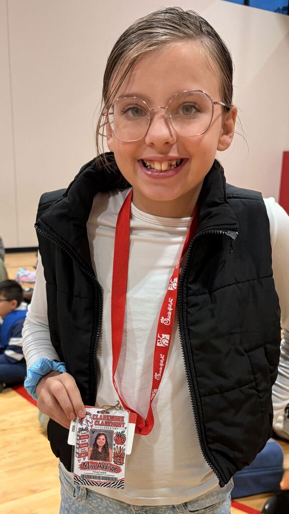 a student smiling dressed as a teacher
