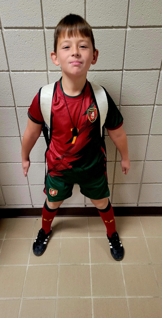 a student smiling dressed as a coach