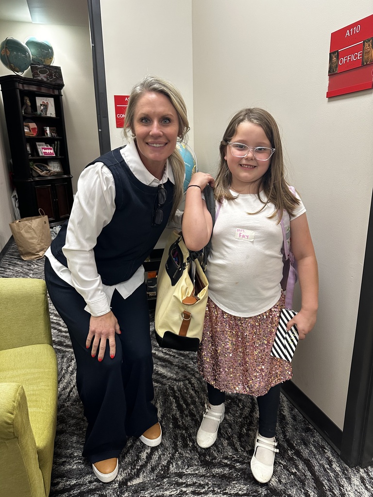 a student and principal smiling dressed as a principal