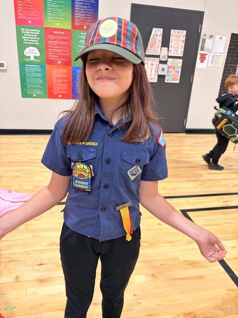 a student smiling dressed as a cub master