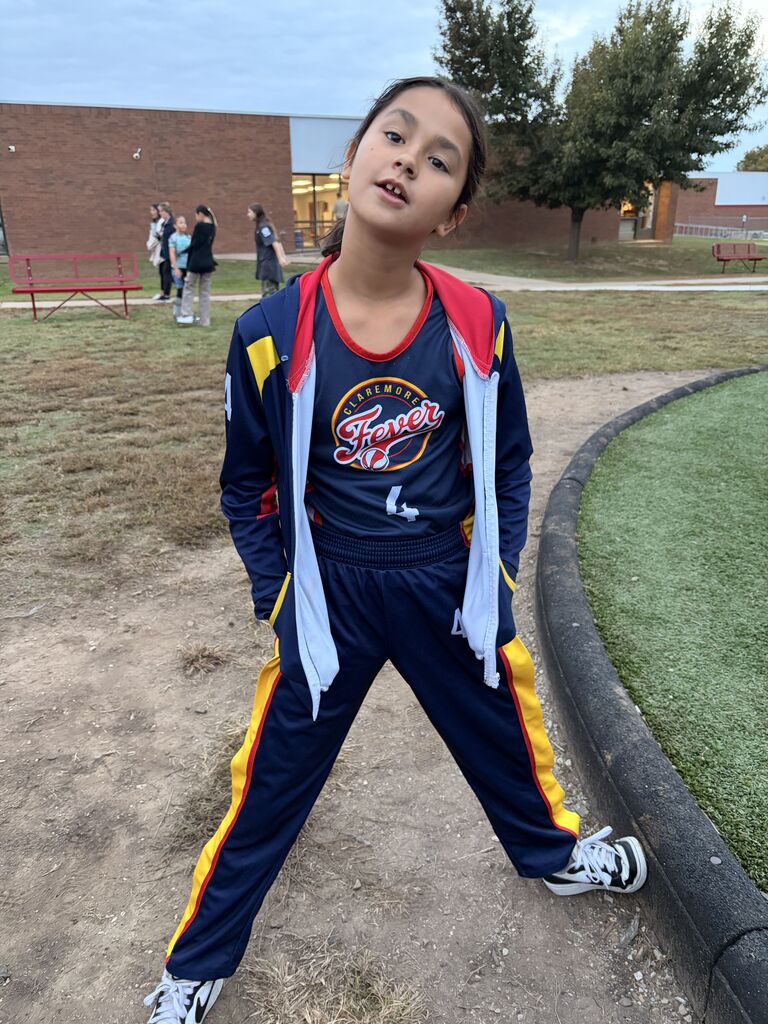 a student smiling dressed as a coach