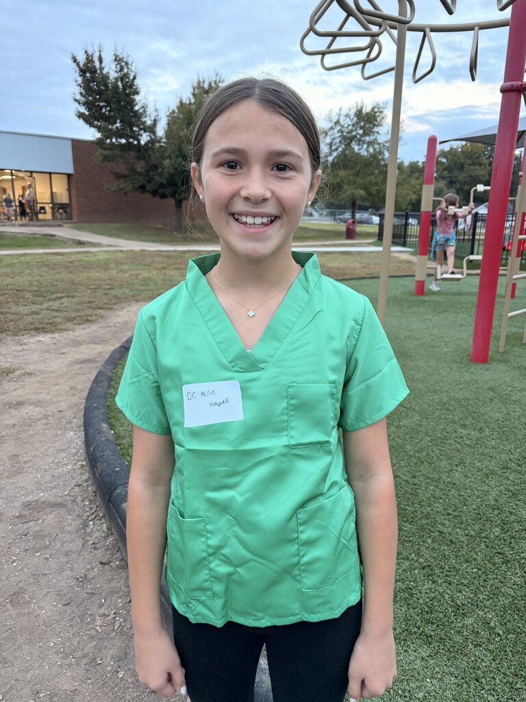 a student smiling dressed as a medical professional
