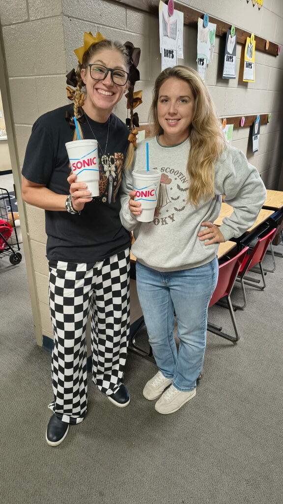teachers holding a sonic drink, smiling
