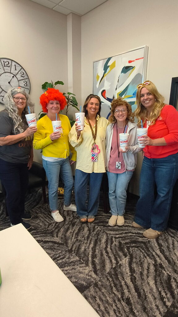 teachers holding a sonic drink, smiling