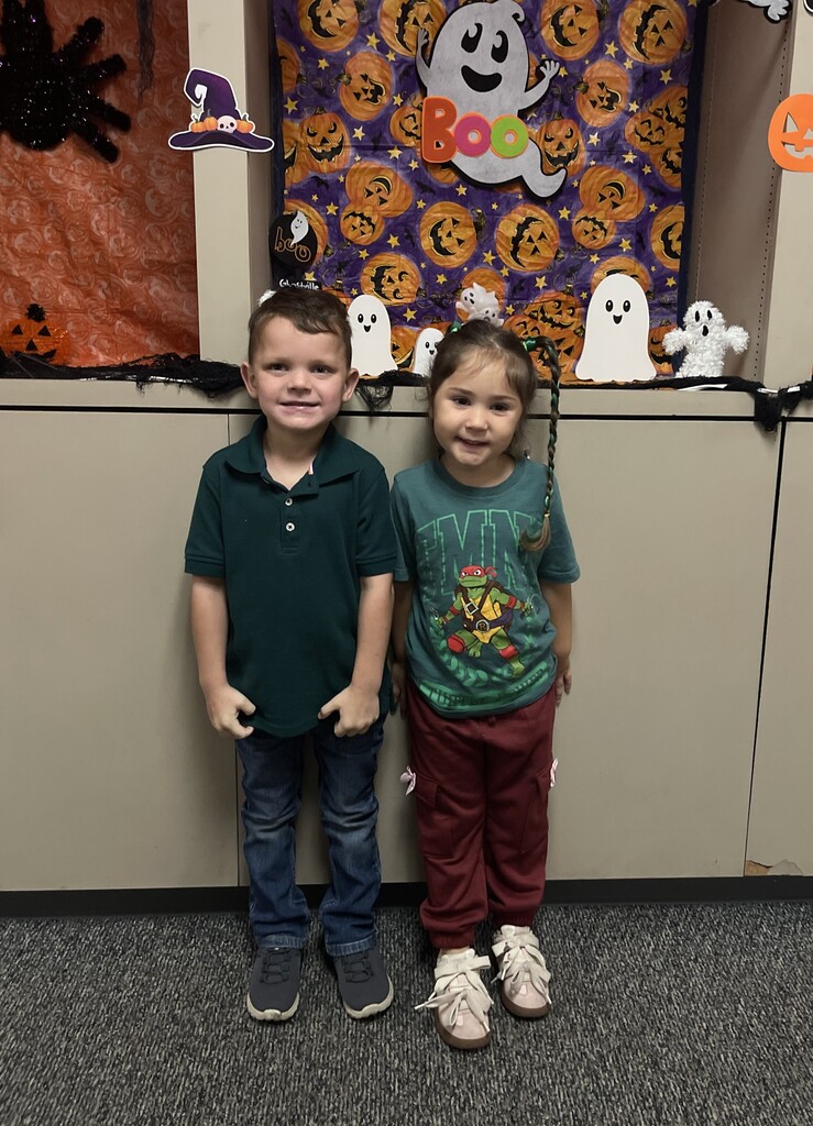 students wearing green and smiling