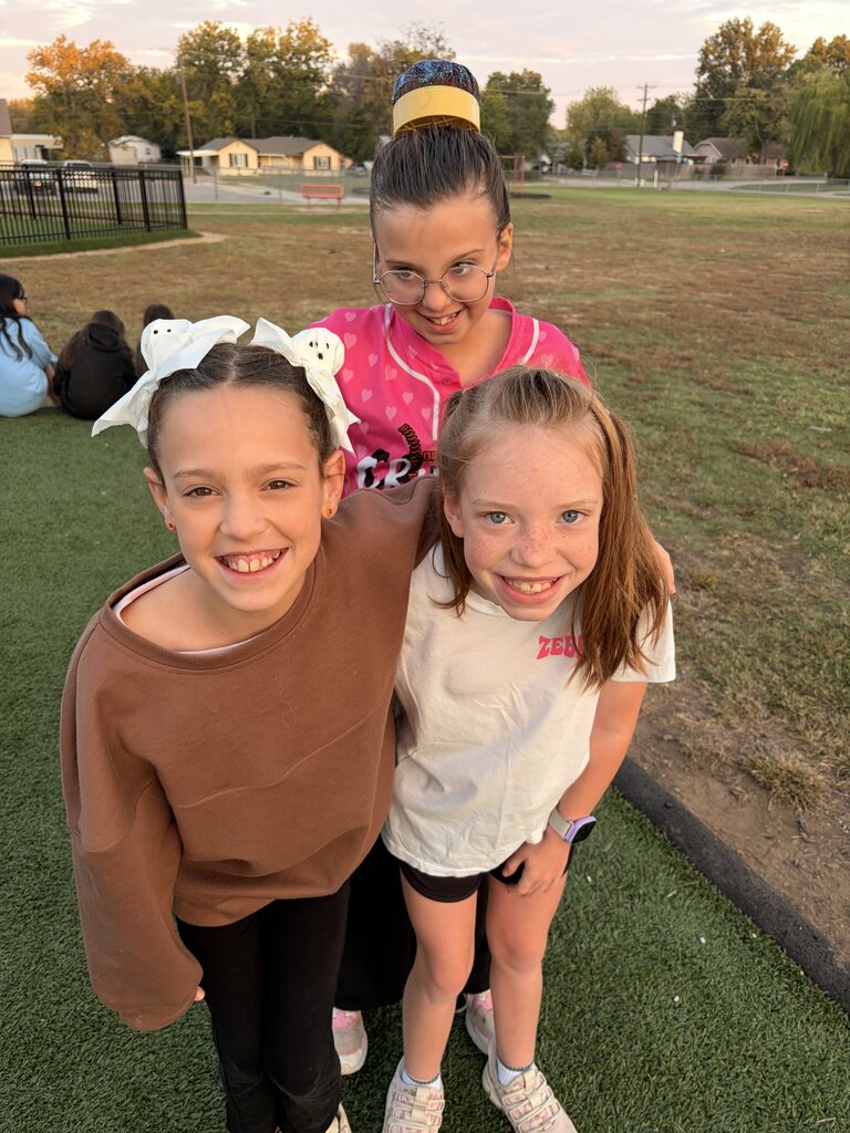 three girls with crazy hair smiling