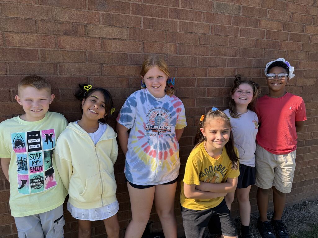 6 students smiling with yellow and crazy hair
