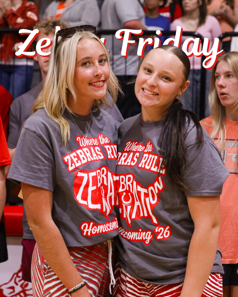 Two students smile in matching gray Zebra Homecoming shirts. Text reads “Zebra Friday.”