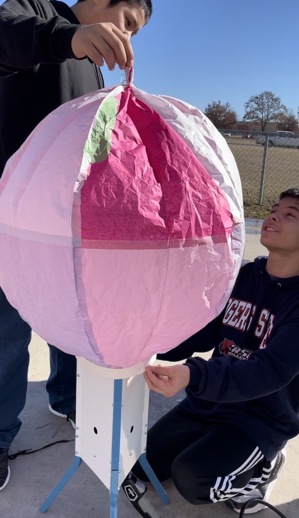 student with homemade hot air balloon