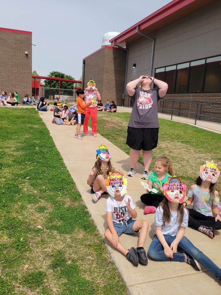 students and teachers observing eclipse