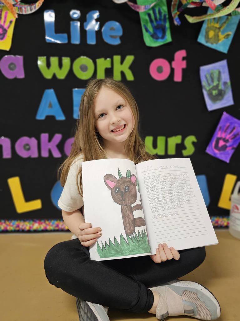 student shows drawing and story of what animal she'd be in published book.