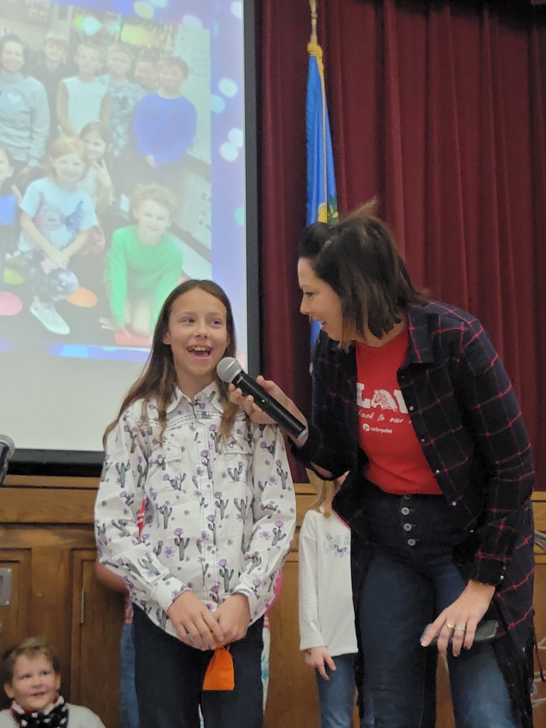 Mrs. Willard interviewing student at school rise and shine assembly