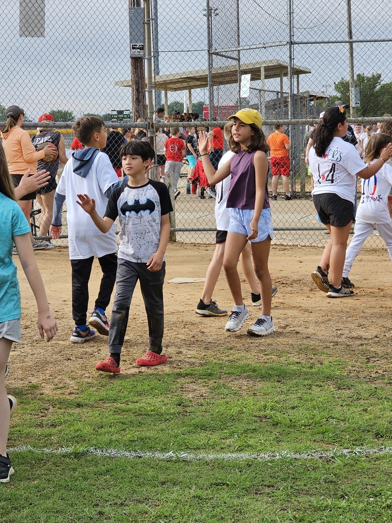 students congratulating after kickball game