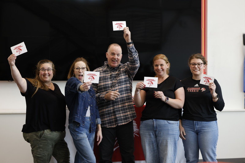 teachers holding cards smiling