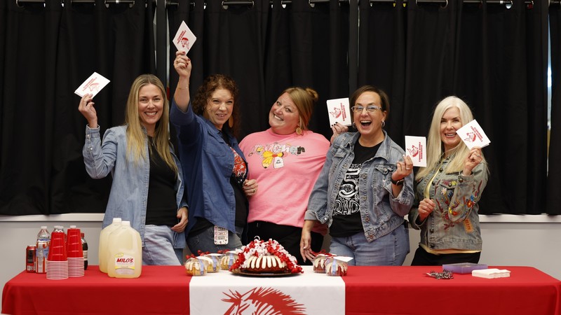 teachers holding cards smiling