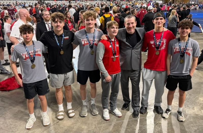 wrestlers with medals and coaches