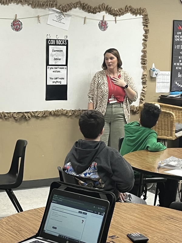 counselor at the front of a classroom 