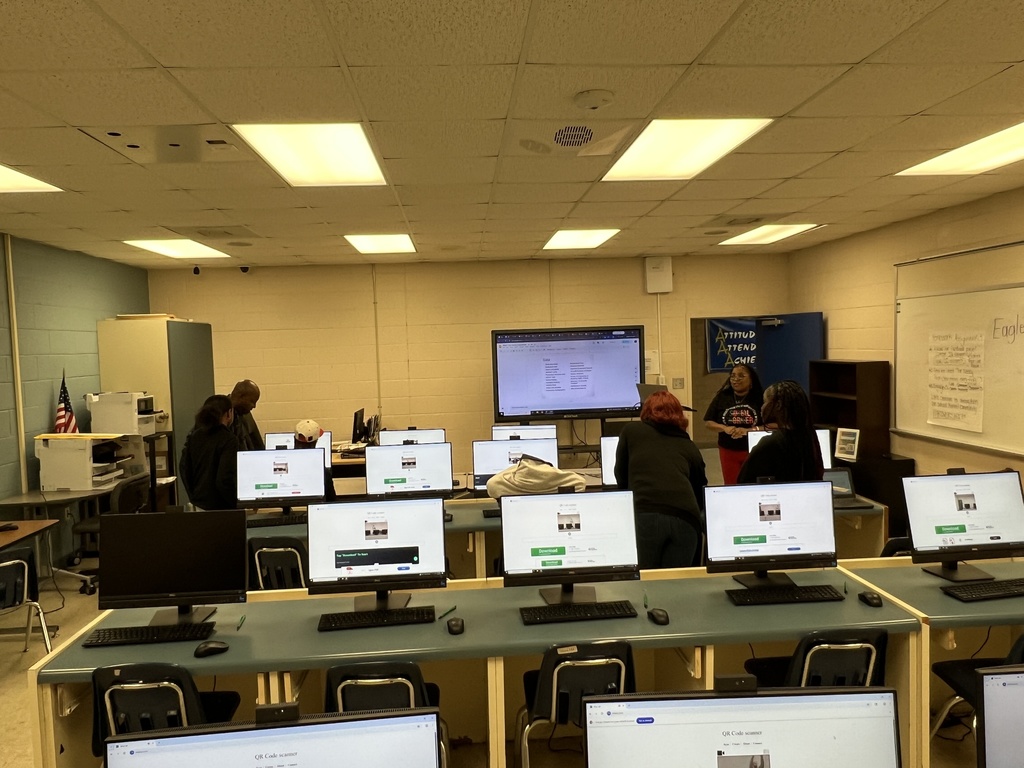 Mrs. Butler and Dr. Cummings assisting parents with completing the parent climate survey