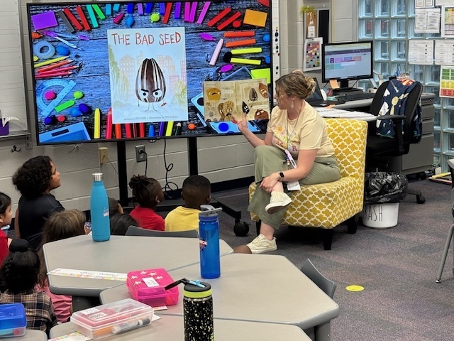 Mrs. Burker's 1st grade students enjoying a new story on their first day of school.