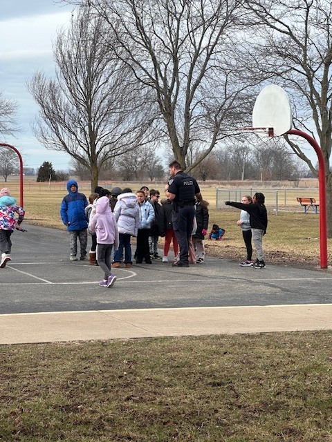 Officer Holderfield playing basketball with our CES students.