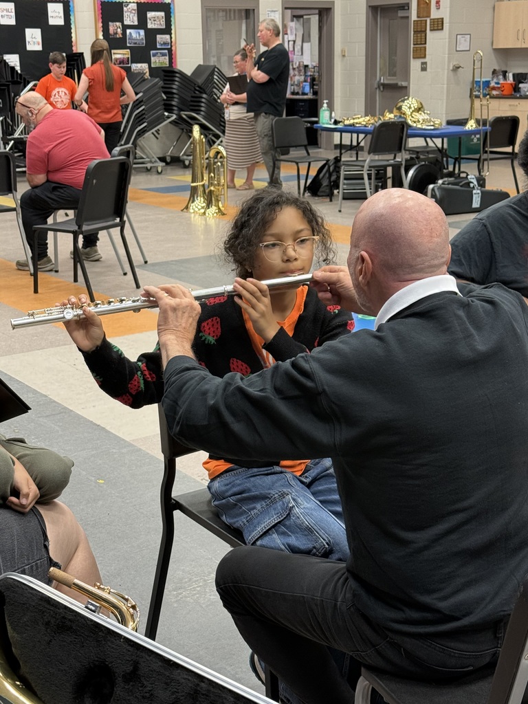 Teacher helping student try instrament