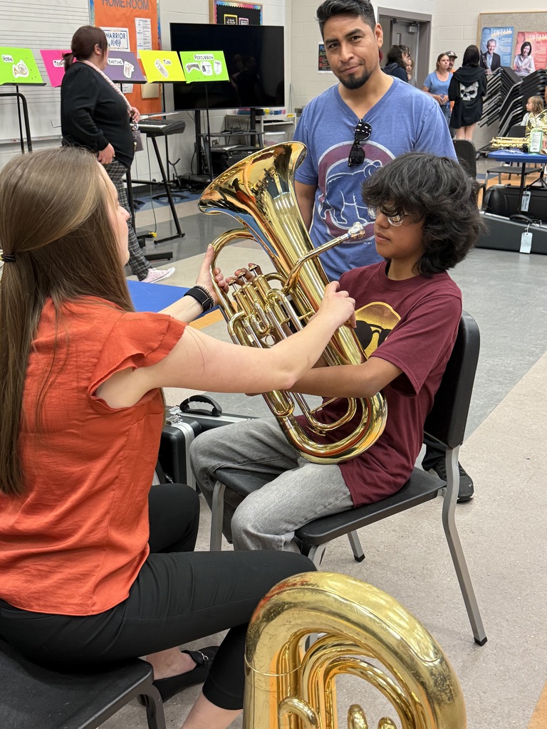 Teacher helping student try instrament