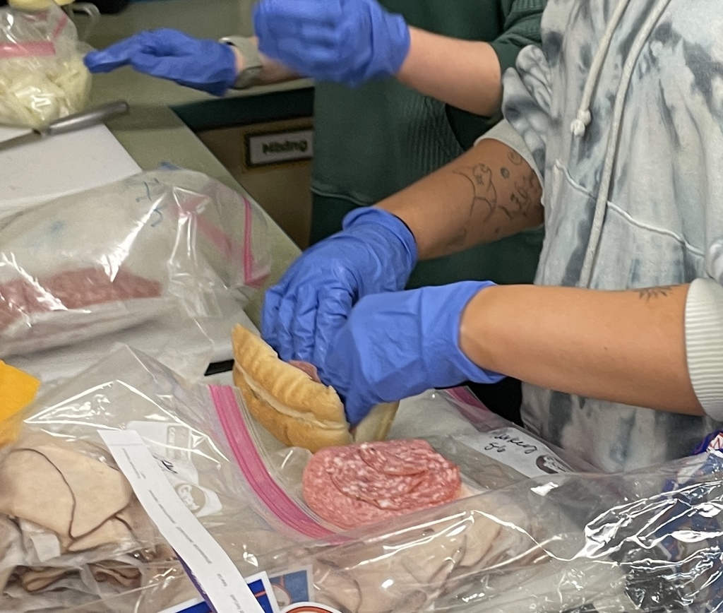 hands preparing sandwiches